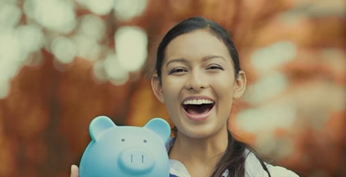 Woman holding a piggy bank