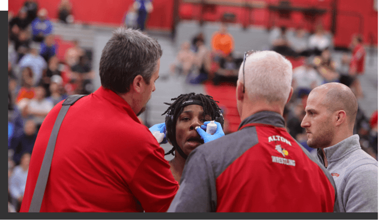 athletic trainers helping wrestler