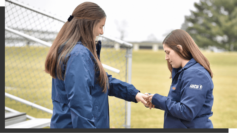 athletic trainer inspecting someones hand