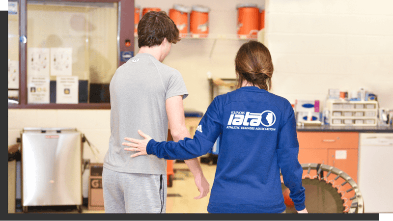athletic trainer helping athlete